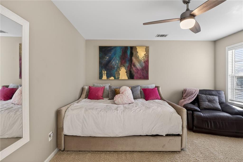 4817 Pepper Tree Lane Douglasville, GA 30135 - Photo 41 of 65 a bedroom with a bed and furniture