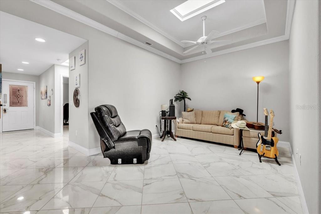 1260 Rio De Janeiro Avenue, Unit 102 Punta Gorda, FL 33983 - Photo 20 of 46 a living room with furniture and a chandelier