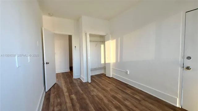 a view of room with window and hardwood floor