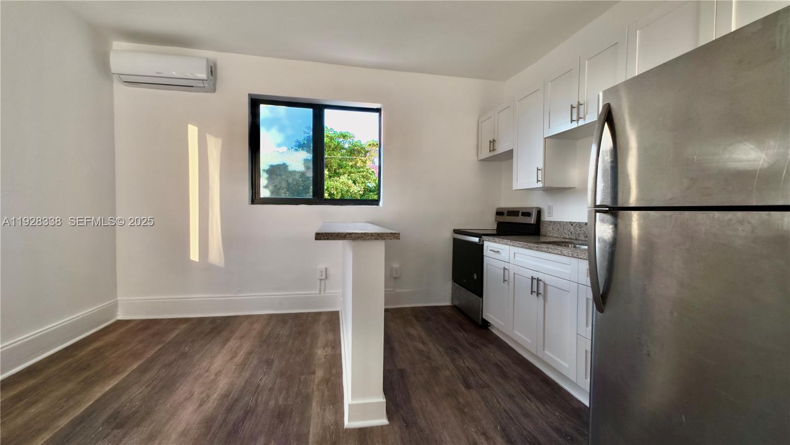 337 Southwest 5th Avenue, Unit 12 Miami, FL 33130 - Photo 3 of 21 a kitchen with a refrigerator a stove top oven and wooden floor