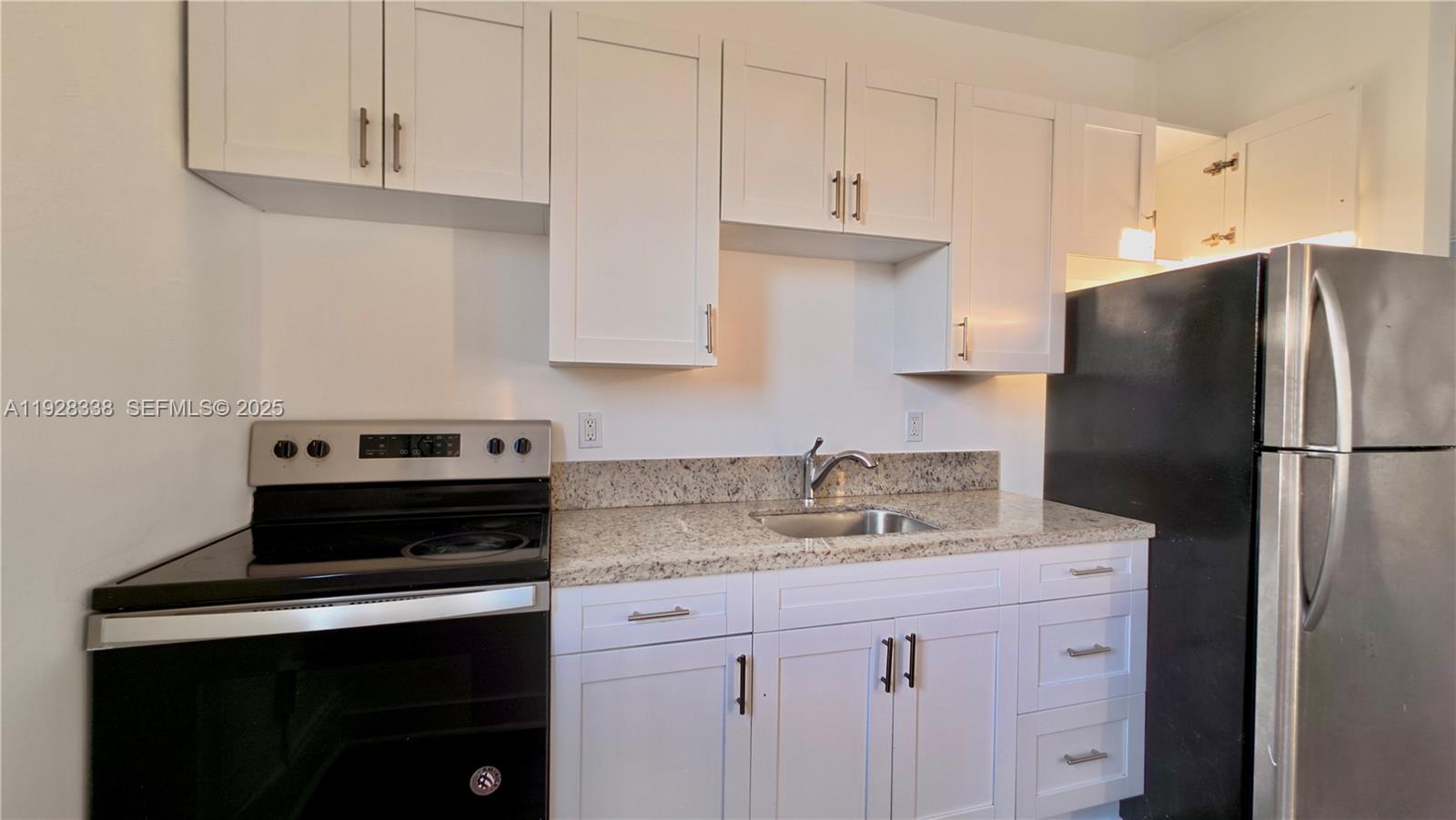 337 Southwest 5th Avenue, Unit 12 Miami, FL 33130 - Photo 6 of 21 a kitchen with a sink stove and refrigerator