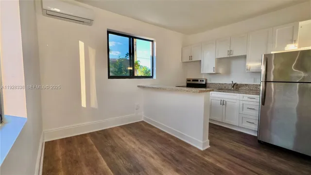 a kitchen with a refrigerator a stove a sink and a window