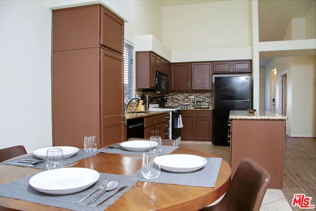 a kitchen with a refrigerator sink and microwave