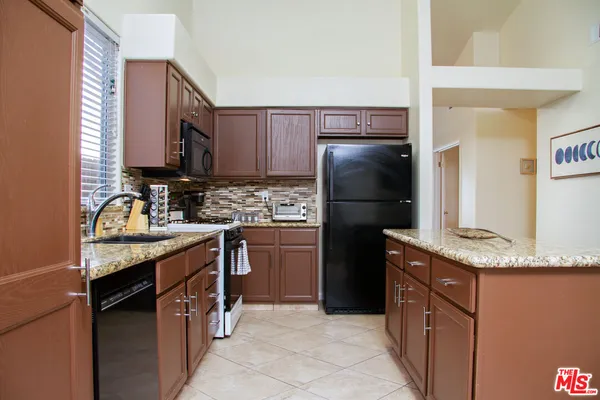 a kitchen with a refrigerator sink and microwave