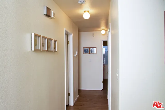 a living room with stainless steel appliances kitchen island granite countertop furniture and a refrigerator