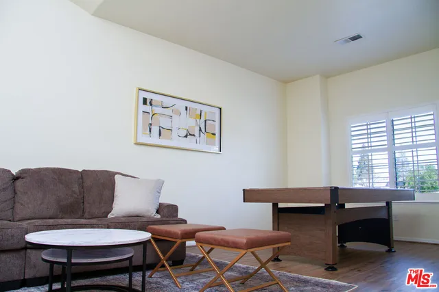 a view of a workspace with furniture and wooden floor