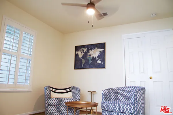 a bedroom with a bed and a painting on the wall