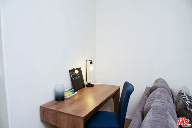 a kitchen with stainless steel appliances a dining table and chairs
