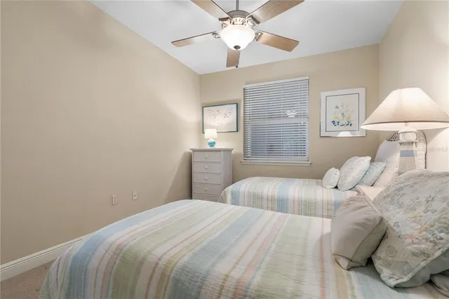 a bedroom with a bed and a large mirror on dresser