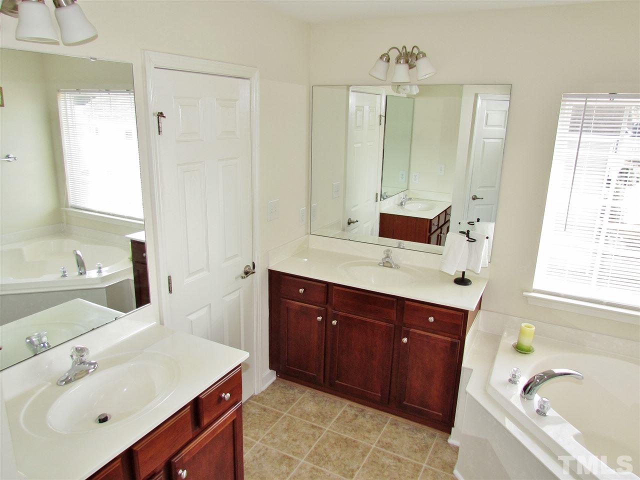 5148 Holly Ridge Farm Road Raleigh, NC 27616 - Photo 14 of 25 a bathroom with a tub sink and mirror