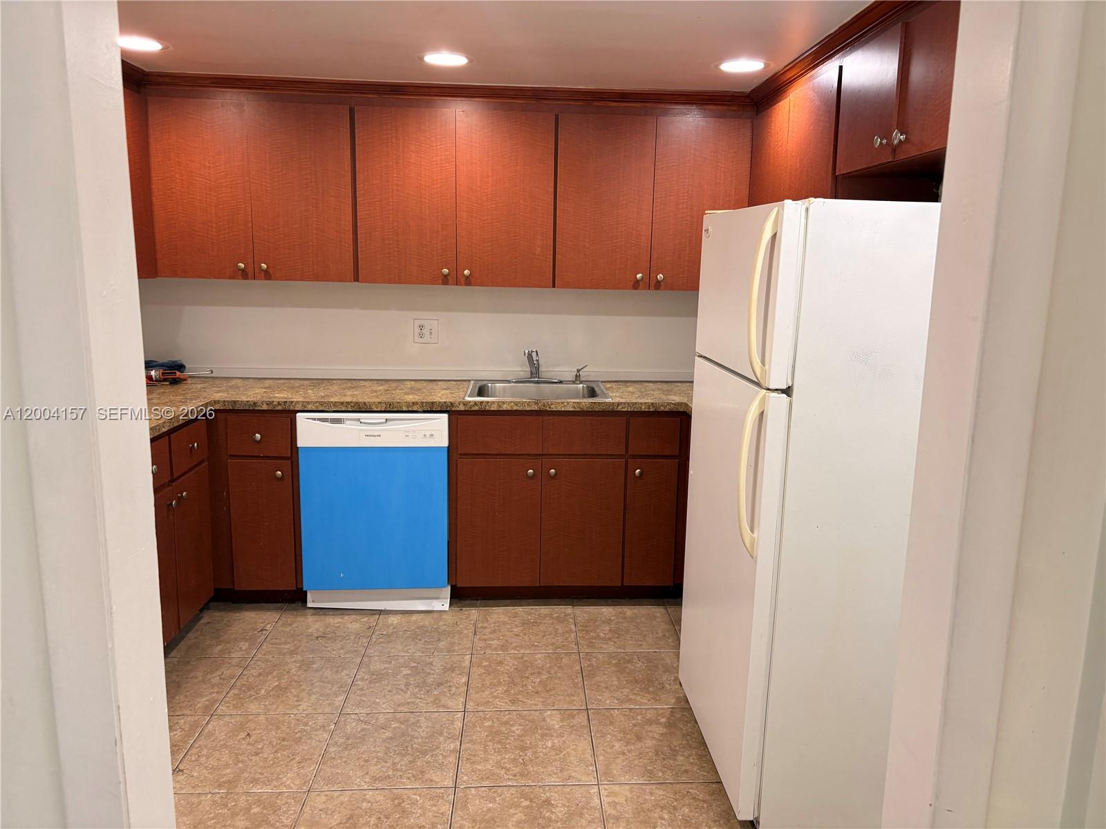 4168 Inverrary Drive, Unit 408 Lauderhill, FL 33319 - Photo 1 of 11 a kitchen with stainless steel appliances granite countertop a refrigerator and a stove