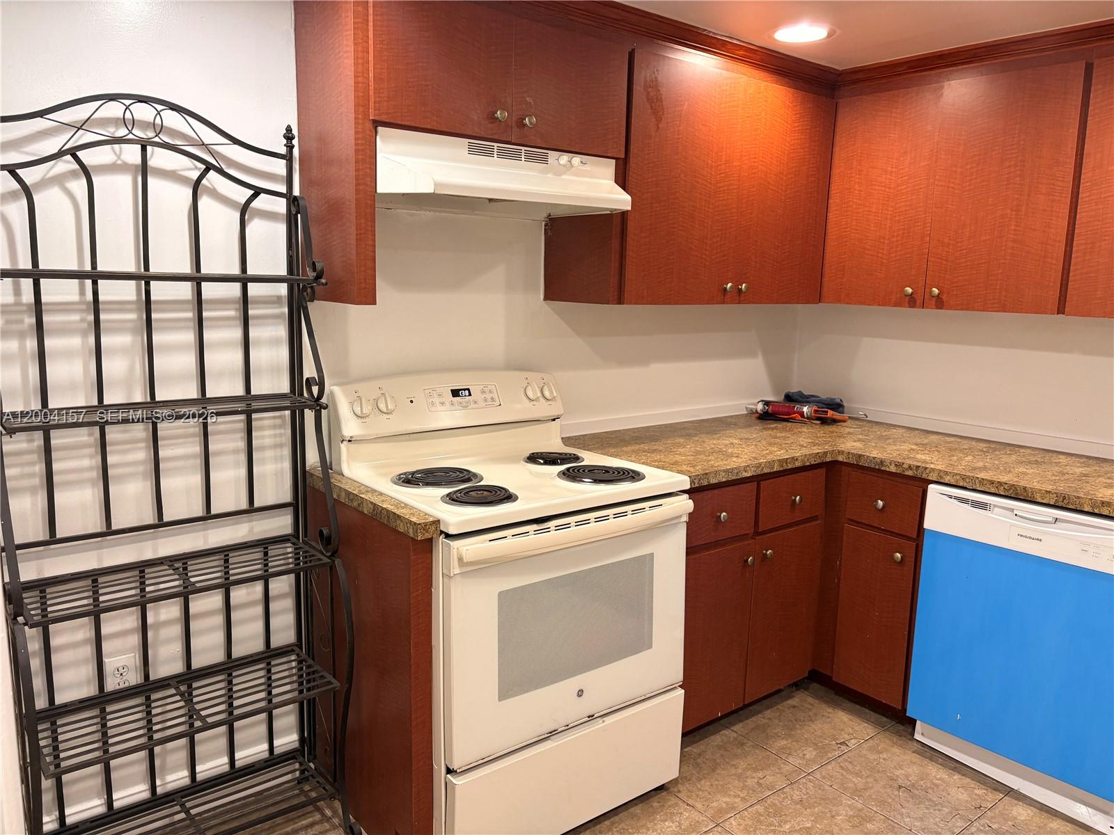 4168 Inverrary Drive, Unit 408 Lauderhill, FL 33319 - Photo 2 of 11 a kitchen with a stove and a microwave