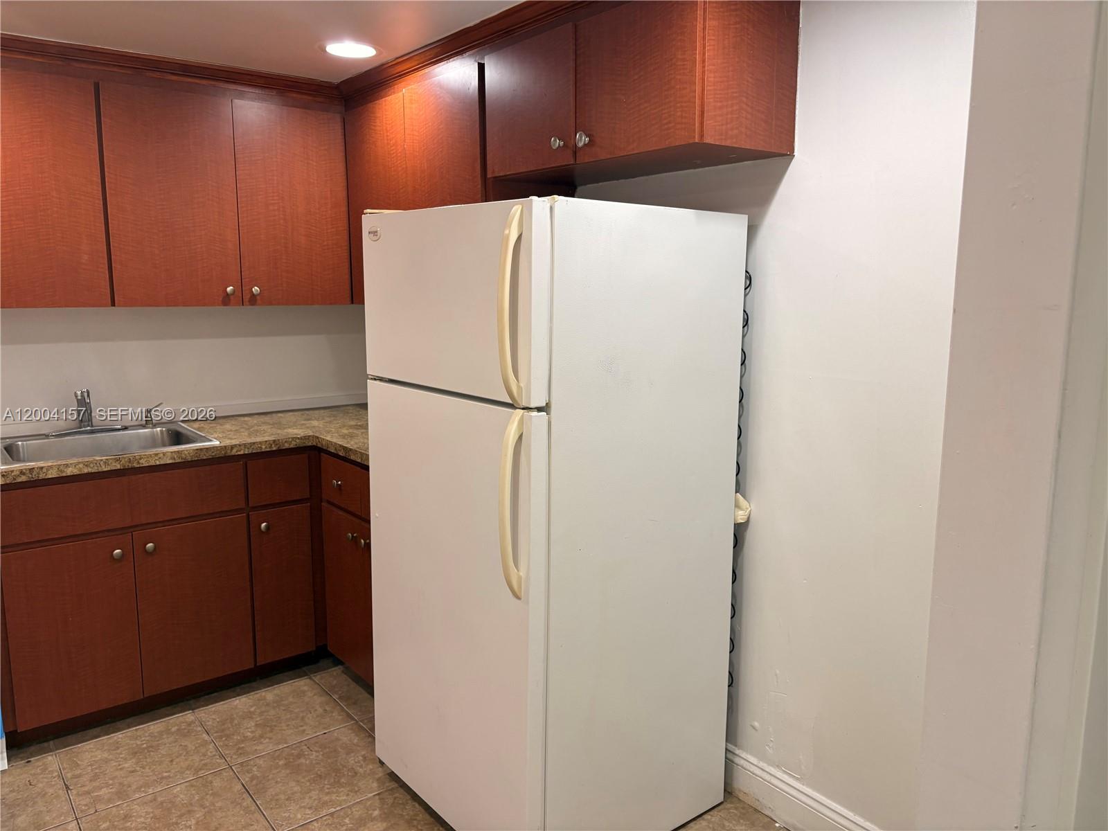 4168 Inverrary Drive, Unit 408 Lauderhill, FL 33319 - Photo 3 of 11 a white refrigerator freezer sitting in a kitchen