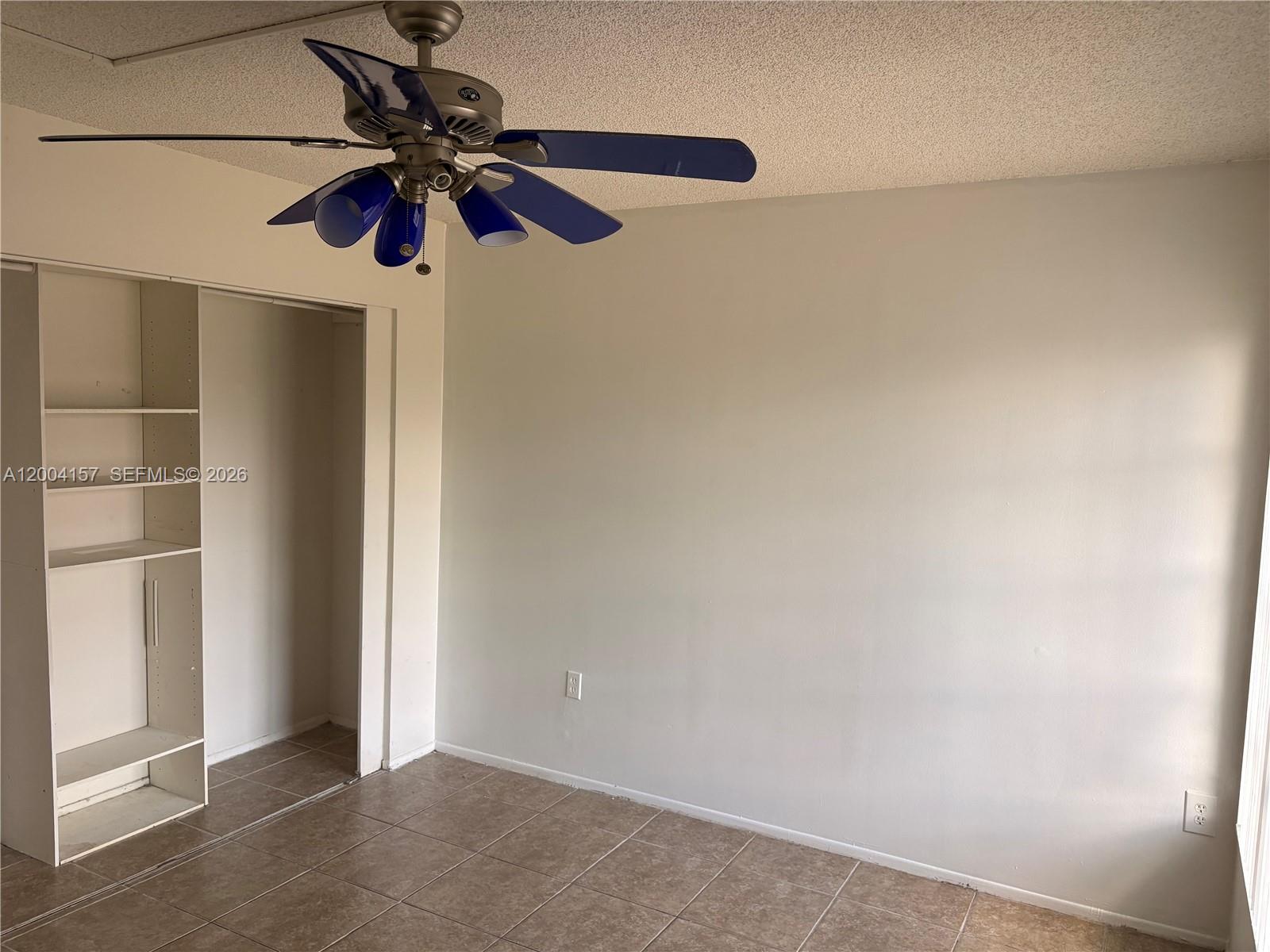 4168 Inverrary Drive, Unit 408 Lauderhill, FL 33319 - Photo 6 of 11 an empty room with a ceiling fan and a window