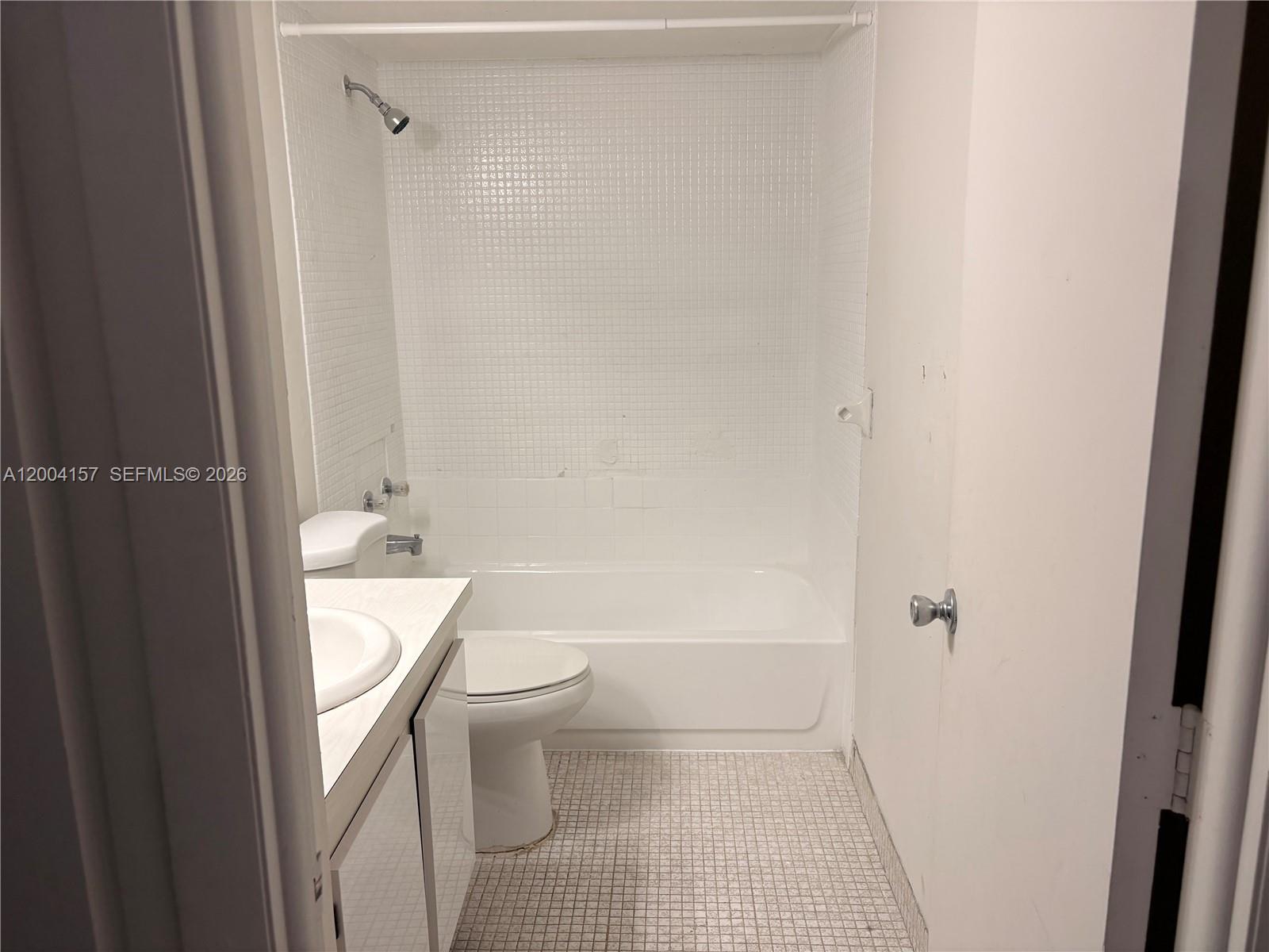 4168 Inverrary Drive, Unit 408 Lauderhill, FL 33319 - Photo 7 of 11 a bathroom with a toilet a sink and shower