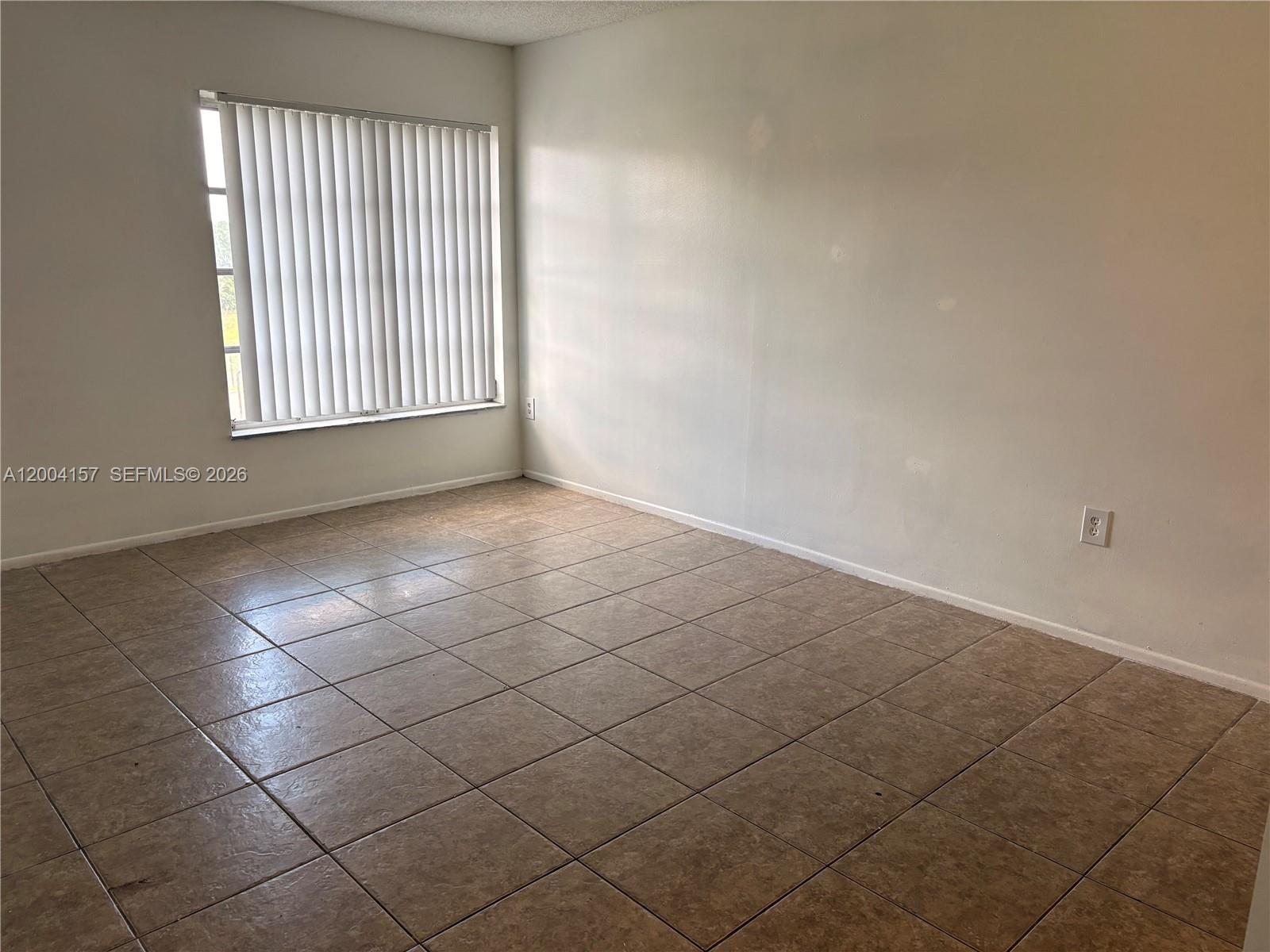4168 Inverrary Drive, Unit 408 Lauderhill, FL 33319 - Photo 8 of 11 an empty room with windows