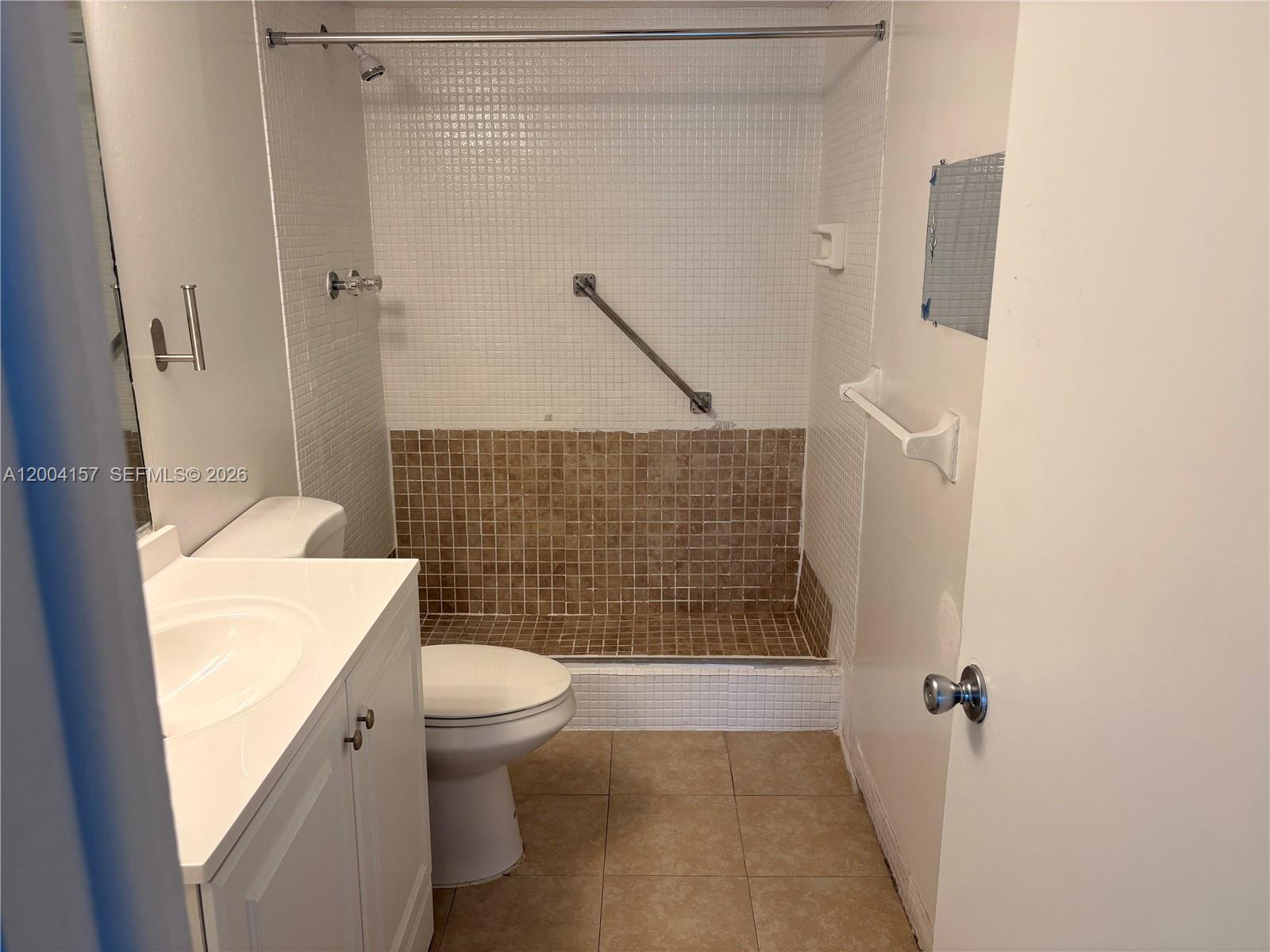4168 Inverrary Drive, Unit 408 Lauderhill, FL 33319 - Photo 9 of 11 a bathroom with a toilet and a shower
