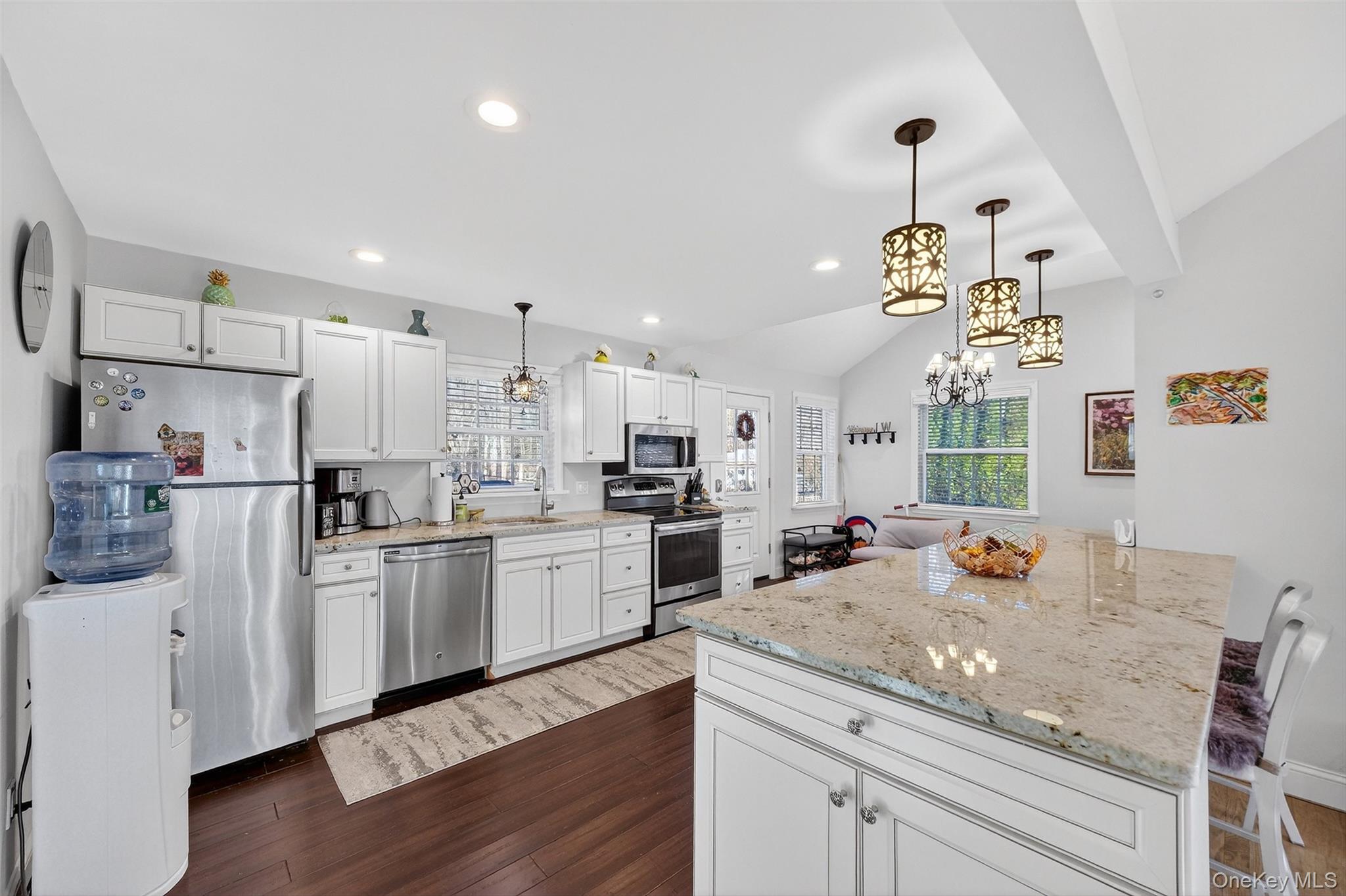 550 Beach Road Mahopac, NY 10541 - Photo 11 of 38 a kitchen with a sink dishwasher stove and white cabinets with wooden floor