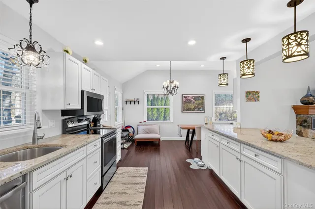 a large kitchen with a large window and stainless steel appliances