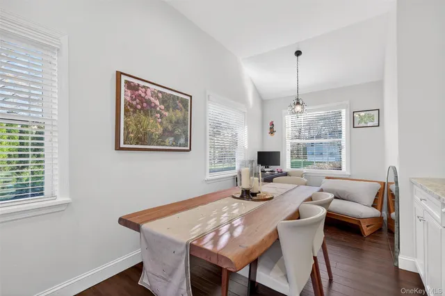 a kitchen with stainless steel appliances granite countertop a stove top oven a sink dishwasher and a refrigerator with wooden floor