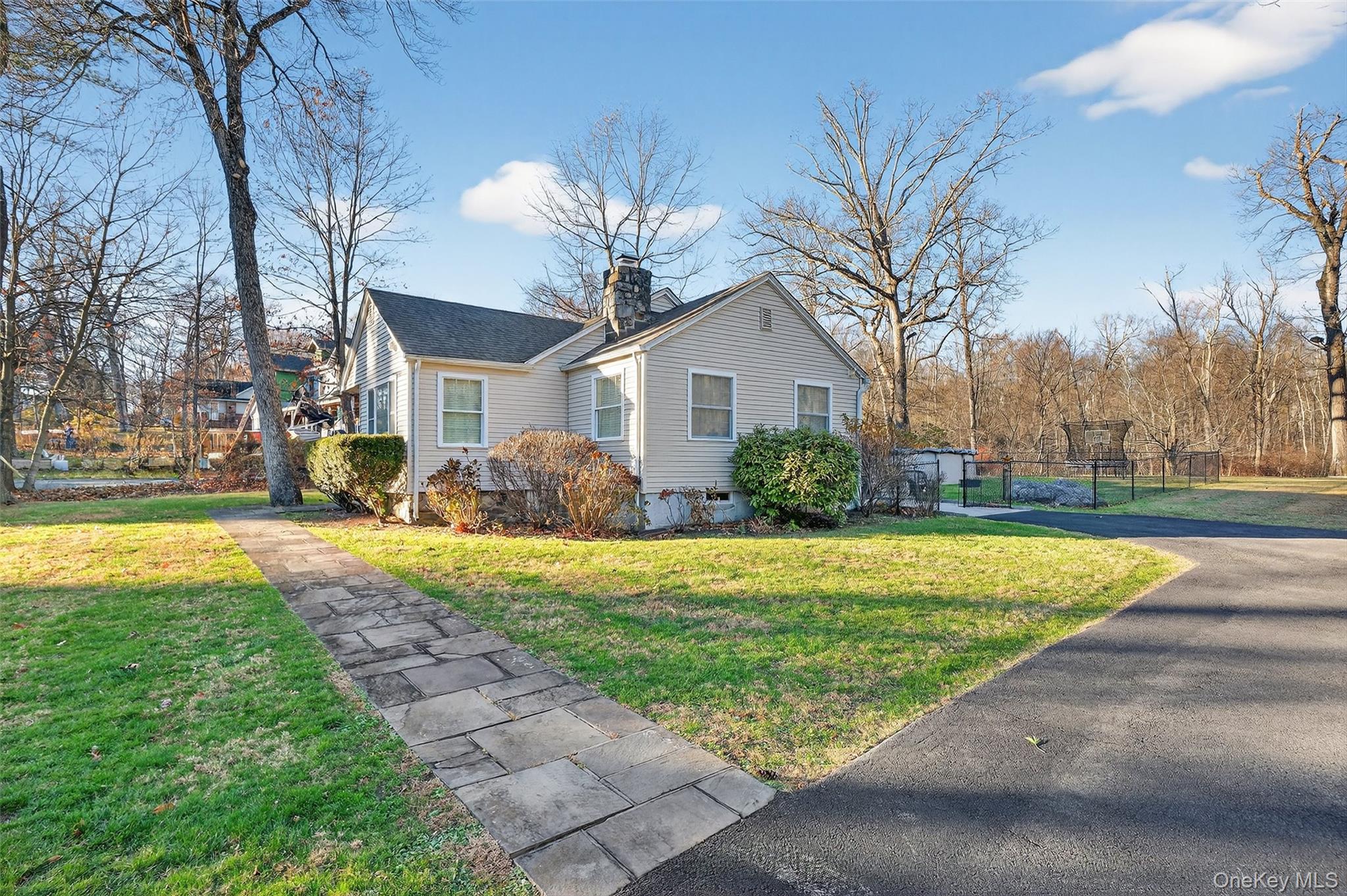 550 Beach Road Mahopac, NY 10541 - Photo 2 of 38 a white house with a large pool yard and palm trees