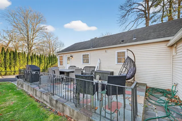 a view of a chairs and table in backyard of the house