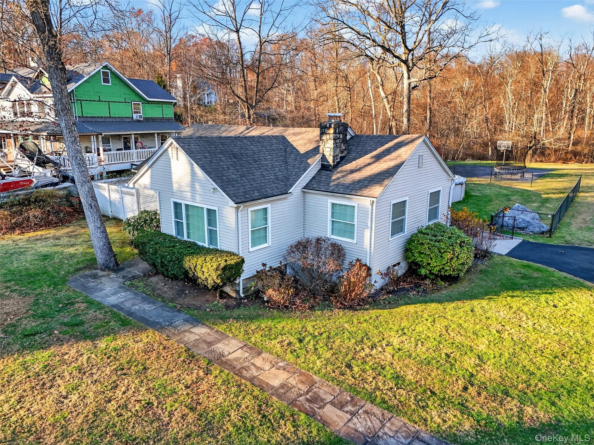 550 Beach Road Mahopac, NY 10541 - Photo 33 of 38 a front view of a house with a yard and potted plants