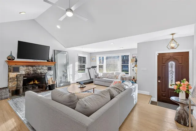 a living room with furniture a fireplace and a flat screen tv