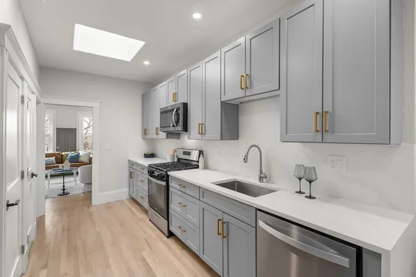 a kitchen with stainless steel appliances a sink stove and cabinets