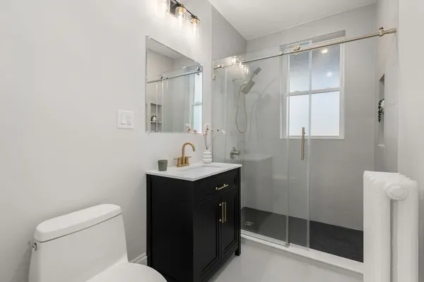 a bathroom with a toilet a sink and shower