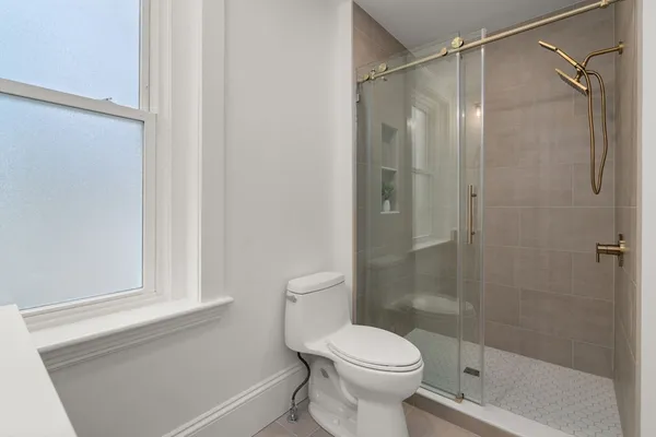 a bathroom with a shower and a toilet