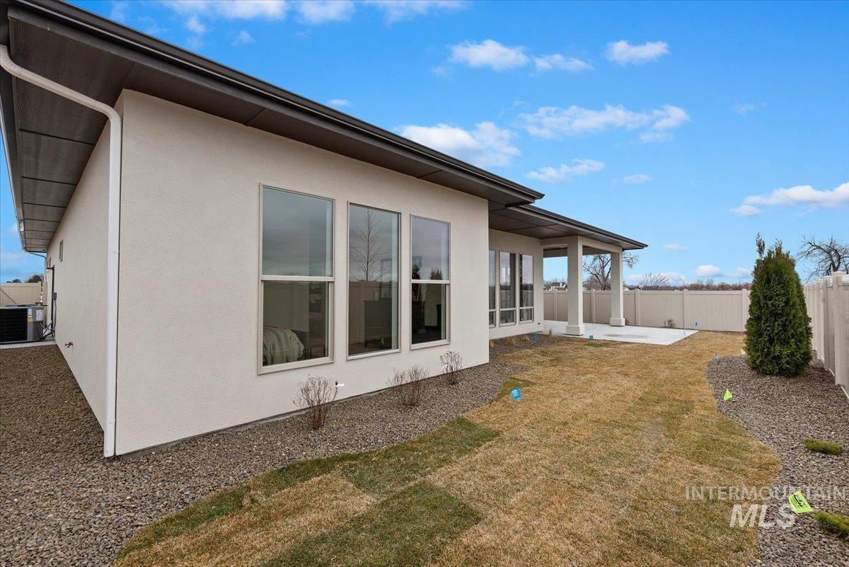 1297 Chena Street Middleton, ID 83644 - Photo 34 of 38 Back of property with a patio, stucco siding, and a fenced backyard