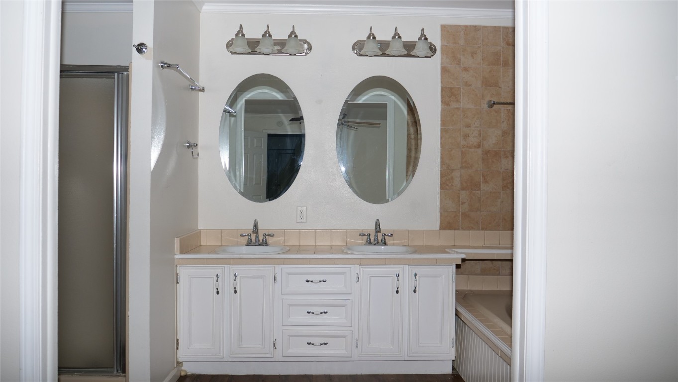 1504 Citation Circle, Unit D Del Valle, TX 78617 - Photo 15 of 25 a bathroom with a granite countertop double vanity sink and a mirror