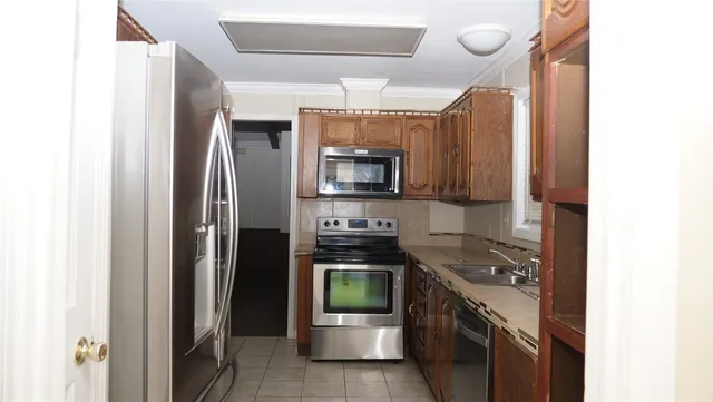 a kitchen with a refrigerator and a stove