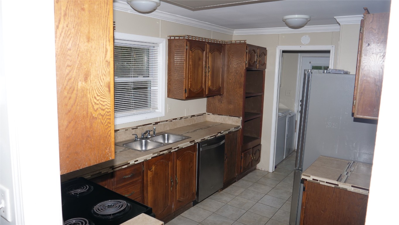 1504 Citation Circle, Unit D Del Valle, TX 78617 - Photo 7 of 25 a kitchen with stainless steel appliances granite countertop a stove and a refrigerator