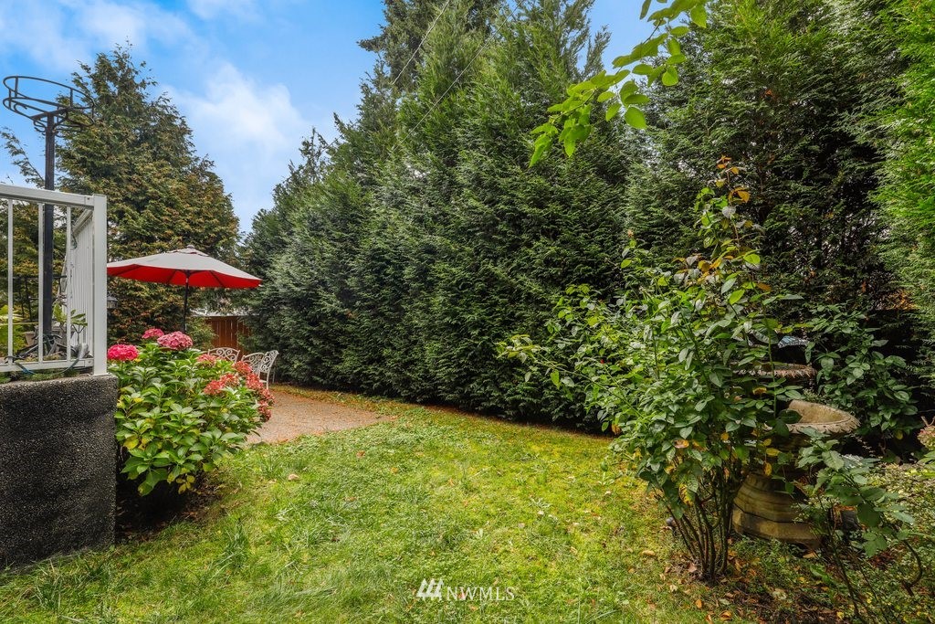 2013 Northeast 15th Street Renton, WA 98056 - Photo 27 of 29 a view of a patio with table and chairs under an umbrella