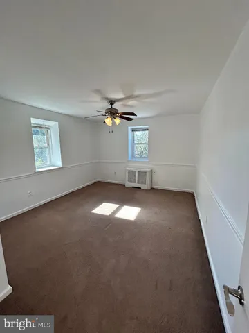 an empty room with a empty space and windows