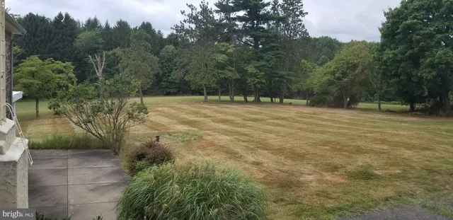 a backyard of a house with lots of green space