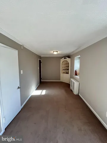 a view of empty room with a fireplace