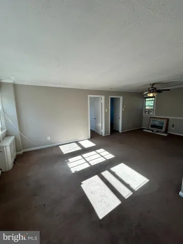 a view of an empty room with windows