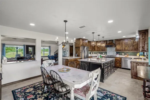 a large kitchen with a table and chairs