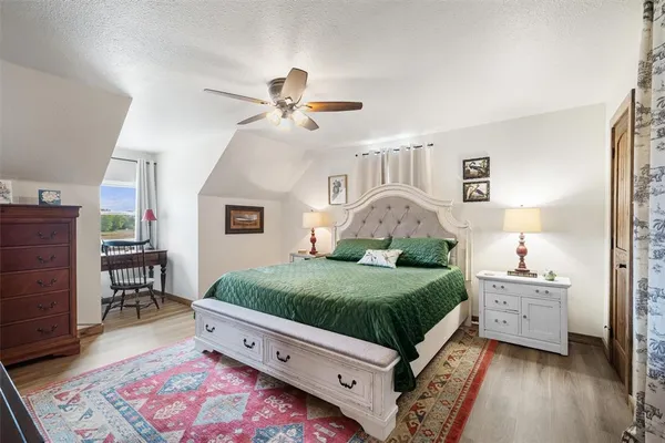 a living room with a bed furniture and a dresser