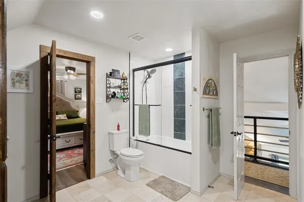 a bathroom with a toilet sink and shower