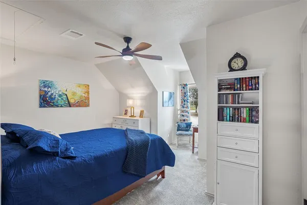 a bed room with a bed and a book shelf