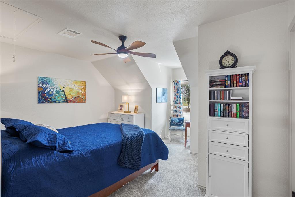 733 Rains County Road 1430 Point, TX 75472 - Photo 22 of 40 a bed room with a bed and a book shelf