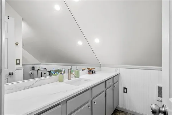 a bathroom with a sink and a mirror