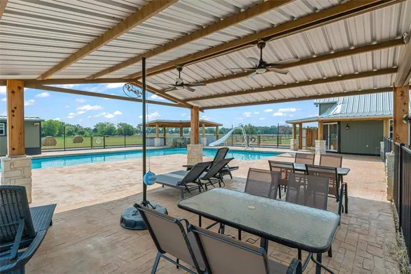 a view of a patio with a table and chairs