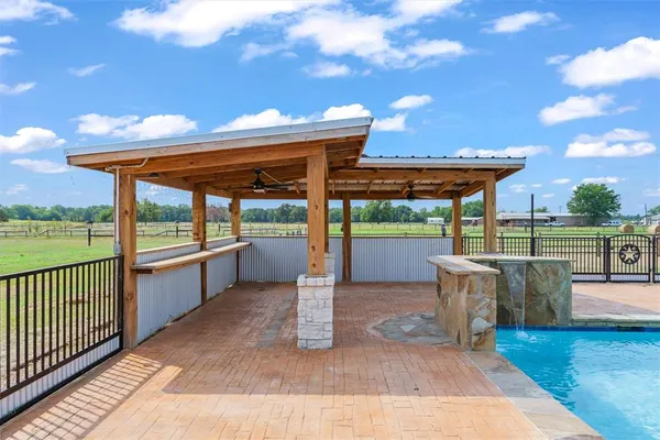 a view of a patio with a table and chairs under an umbrella with wooden floor