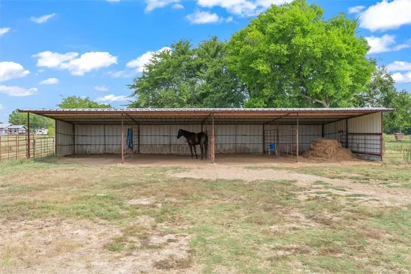 a view of a house with a yard and a garage