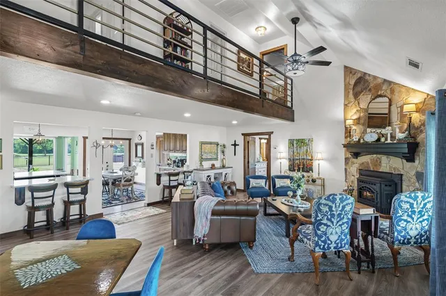 a living room with lots of furniture and hard wood flooring